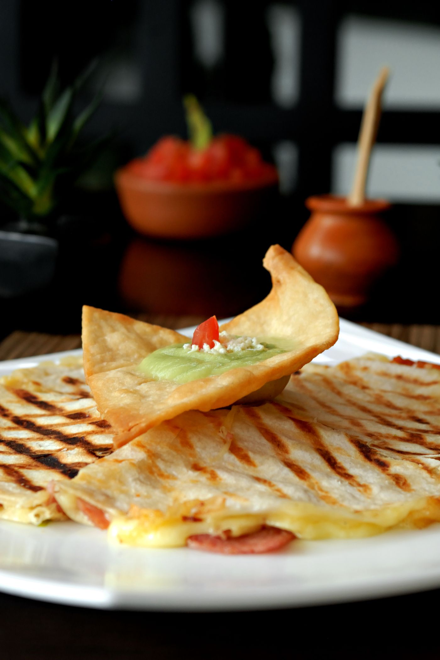 Grilled cheese quesadilla served with guacamole and salsa
